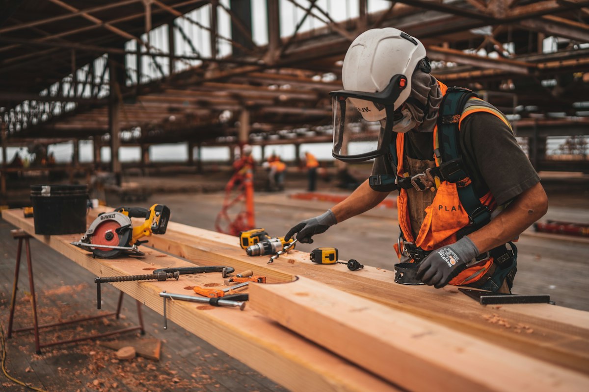 Carpenter carefully cutting timber during a home renovation