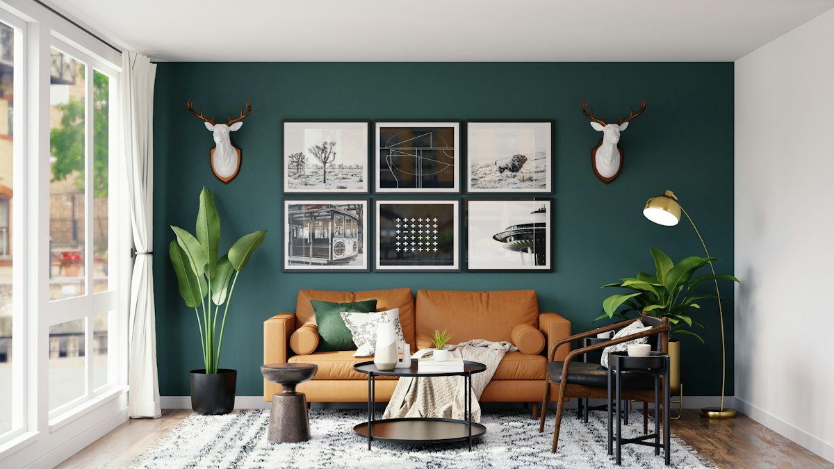 Living room refreshed with a deep green feature wall and warm leather sofa
